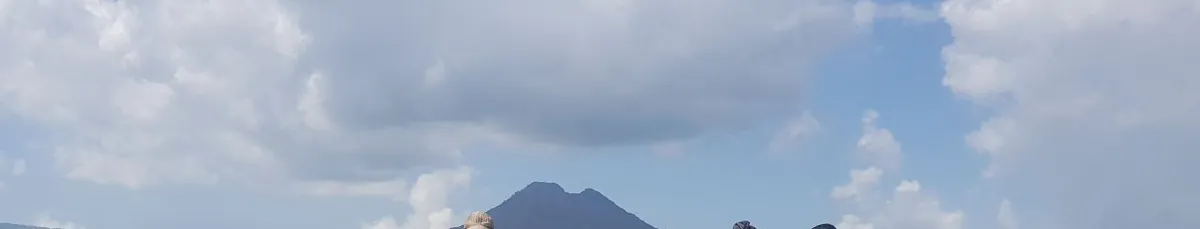 Mount Batur volcano rising above the clouds, seen from a Kintamani viewpoint