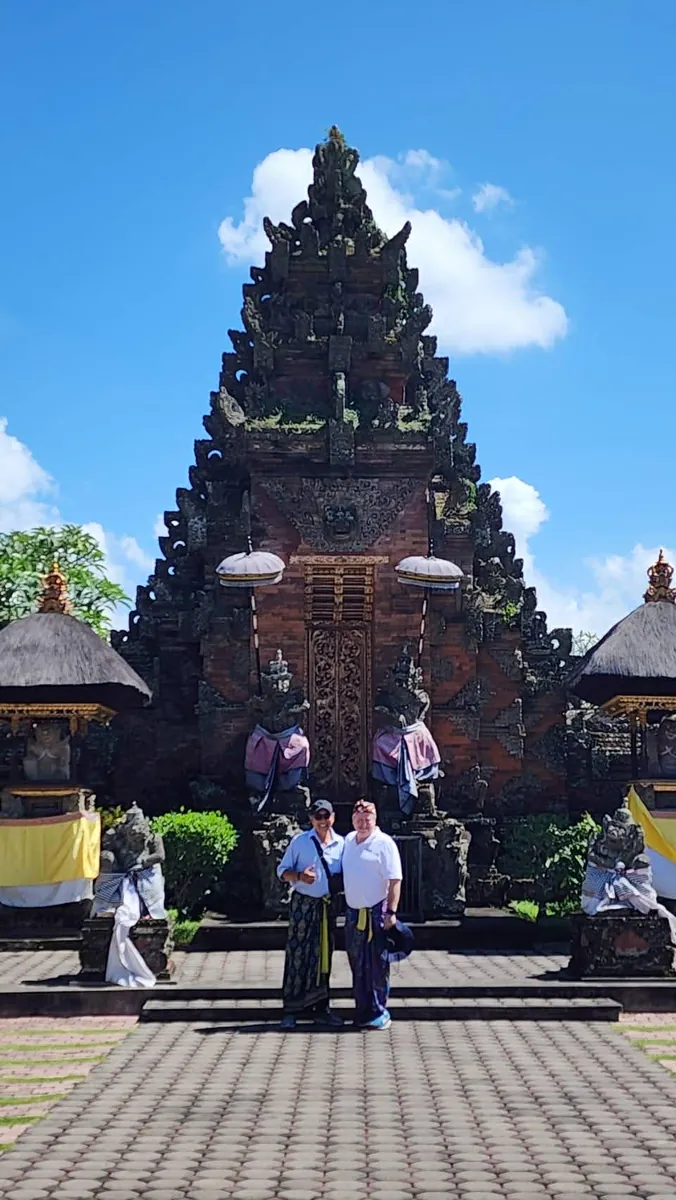 Ornate split gate of a Balinese Hindu temple against a bright blue sky